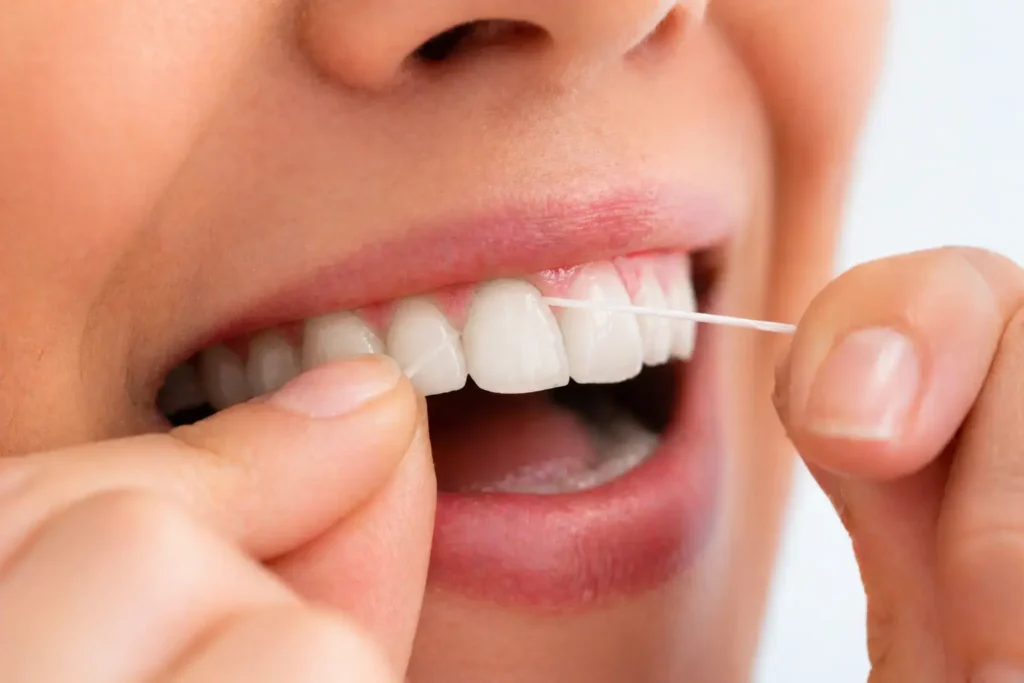floss cleaning between teeth removing plaque